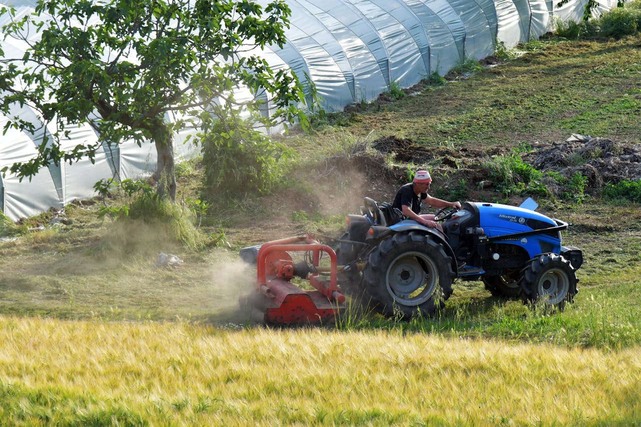 A man driving a tractor in a field near Rizza, Veneto, Italy.